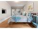 Bedroom featuring warm hardwood floors, large closet and soft lighting at 2377 Cherry St, Denver, CO 80207