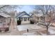 Charming home with a well-maintained front yard, snow-covered ground, and a cozy front porch at 2377 Cherry St, Denver, CO 80207