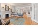 Inviting living room with hardwood floors, fireplace, and open layout to the dining area at 2377 Cherry St, Denver, CO 80207