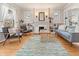 Inviting living room with hardwood floors, a cozy seating area, and a decorative fireplace with charming built-in shelving at 2377 Cherry St, Denver, CO 80207