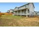 Backyard view of a two-story home with a deck and fenced yard, showcasing outdoor living space at 641 Sunrise St, Erie, CO 80516