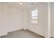 Simple, carpeted bedroom with white walls and a window that lets in natural light at 641 Sunrise St, Erie, CO 80516