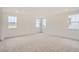 Bright, spacious carpeted bedroom with large windows and neutral walls, offering a comfortable and inviting space at 641 Sunrise St, Erie, CO 80516