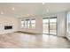 Bright living room featuring a fireplace, recessed lighting, wood-look floors, and a sliding glass door at 641 Sunrise St, Erie, CO 80516