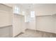 Bright walk-in closet with carpeted floor, multiple shelves, and a view from two windows at 641 Sunrise St, Erie, CO 80516