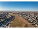 Aerial view of a residential area with mountain views in the background at 16508 E 111Th Pl, Commerce City, CO 80022