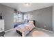 Bright bedroom with a twin bed, window, and plenty of storage at 16508 E 111Th Pl, Commerce City, CO 80022