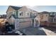 Two-story house with stone accents and a two-car garage at 16508 E 111Th Pl, Commerce City, CO 80022