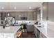 Modern kitchen with gray cabinets, white countertops, and stainless steel appliances at 16508 E 111Th Pl, Commerce City, CO 80022