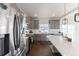 Modern kitchen with gray cabinets, stainless steel appliances, and an island at 16508 E 111Th Pl, Commerce City, CO 80022