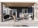 Relaxing covered patio with seating, grill and fire pit at 16508 E 111Th Pl, Commerce City, CO 80022