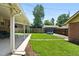 Backyard with covered patio features lush lawn and trampoline for backyard fun at 2549 Holly St, Denver, CO 80207