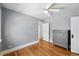 Cozy bedroom with hardwood floors, neutral paint, and a gray dresser in a well-lit space at 2549 Holly St, Denver, CO 80207