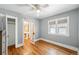 Bedroom with hardwood floors and an attached bathroom at 2549 Holly St, Denver, CO 80207