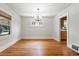 Cozy dining room features classic chandelier lighting and natural light from the windows at 2549 Holly St, Denver, CO 80207