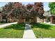 Charming brick home with a welcoming front porch and well-manicured lawn at 2549 Holly St, Denver, CO 80207