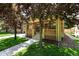 Quaint brick home with a welcoming front porch and lush green lawn at 2549 Holly St, Denver, CO 80207