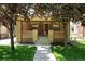 Charming brick home with a cozy front porch and well-manicured lawn, perfect curb appeal at 2549 Holly St, Denver, CO 80207