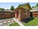 A brick outbuilding featuring a charming exterior and a fenced yard with potential for garden or outdoor living space at 2549 Holly St, Denver, CO 80207