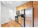 Efficient kitchen area features stainless steel appliances, including range and fridge at 2549 Holly St, Denver, CO 80207