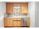 Bright kitchen area has stainless steel dishwasher and stylish cabinetry at 2549 Holly St, Denver, CO 80207