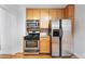 Stainless steel appliances include range and fridge at 2549 Holly St, Denver, CO 80207