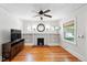 Inviting living room with hardwood floors, fireplace, built-in shelving and ceiling fan at 2549 Holly St, Denver, CO 80207