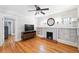 Spacious living room with hardwood floors, built-in shelves, and a decorative fireplace at 2549 Holly St, Denver, CO 80207