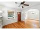 Cozy living room featuring hardwood floors, ample natural light and ceiling fan at 2549 Holly St, Denver, CO 80207