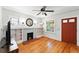 Bright living room with hardwood floors, fireplace, and built-in shelving at 2549 Holly St, Denver, CO 80207