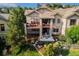 Exterior view of the backyard featuring an outdoor patio, stone pillars, and beautiful landscaping at 5149 Le Duc Ln, Castle Rock, CO 80108