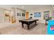 Recreational space features a billiards table, open staircase, and vintage-inspired decor at 5149 Le Duc Ln, Castle Rock, CO 80108