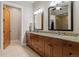 Bathroom with double sinks, wood cabinets and access to the walk in shower at 5149 Le Duc Ln, Castle Rock, CO 80108