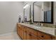 Bathroom with double vanity, granite countertops, and a shower-tub combination in the background at 5149 Le Duc Ln, Castle Rock, CO 80108