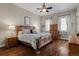 Cozy bedroom featuring hardwood floors, a ceiling fan, and a large wooden bed frame at 5149 Le Duc Ln, Castle Rock, CO 80108