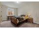 Cozy bedroom with a wooden bed frame, a side table with lamp, and view to the outside at 5149 Le Duc Ln, Castle Rock, CO 80108