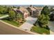 Stunning home featuring a stone facade, lush landscaping, and a long driveway leading to a two-car garage at 5149 Le Duc Ln, Castle Rock, CO 80108