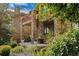 Stunning patio with stone columns and fireplace overlooking lush garden area with seating and views at 5149 Le Duc Ln, Castle Rock, CO 80108