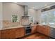 Well-lit kitchen features granite countertops, stainless steel appliances, and wood flooring at 5149 Le Duc Ln, Castle Rock, CO 80108