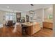 Open-concept kitchen featuring hardwood floors, an island with bar stools, and a view into the living room at 5149 Le Duc Ln, Castle Rock, CO 80108