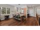 Well-lit kitchen featuring hardwood floors, a center island with stools, and stainless steel appliances at 5149 Le Duc Ln, Castle Rock, CO 80108