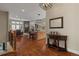 Open-concept living room featuring hardwood floors, fireplace, and kitchen with island and bar stools at 5149 Le Duc Ln, Castle Rock, CO 80108