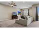 Spacious living room with a large sectional sofa, ceiling fan and sliding door to the outside at 5149 Le Duc Ln, Castle Rock, CO 80108