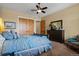 Serene bedroom with a comfortable bed, dresser, and spacious closet featuring wood doors at 5149 Le Duc Ln, Castle Rock, CO 80108