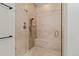 Bright neutral colored tiled shower with built-in seat and sleek fixtures at 5149 Le Duc Ln, Castle Rock, CO 80108