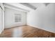 Serene bedroom features wood-look floors, white walls, and natural light from window at 9700 E Iliff Ave # B13, Denver, CO 80231