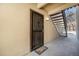 Entrance of condo with decorative security door, staircase, and a welcome mat at 9700 E Iliff Ave # B13, Denver, CO 80231