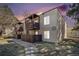 Inviting condo building with private balconies, manicured lawn, and a peaceful walking path at 9700 E Iliff Ave # B13, Denver, CO 80231