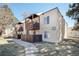 Inviting condo building with private balconies, manicured lawn, and a peaceful walking path at 9700 E Iliff Ave # B13, Denver, CO 80231