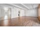 Bright open-concept living room with gleaming floors and white beamed ceiling at 9700 E Iliff Ave # B13, Denver, CO 80231